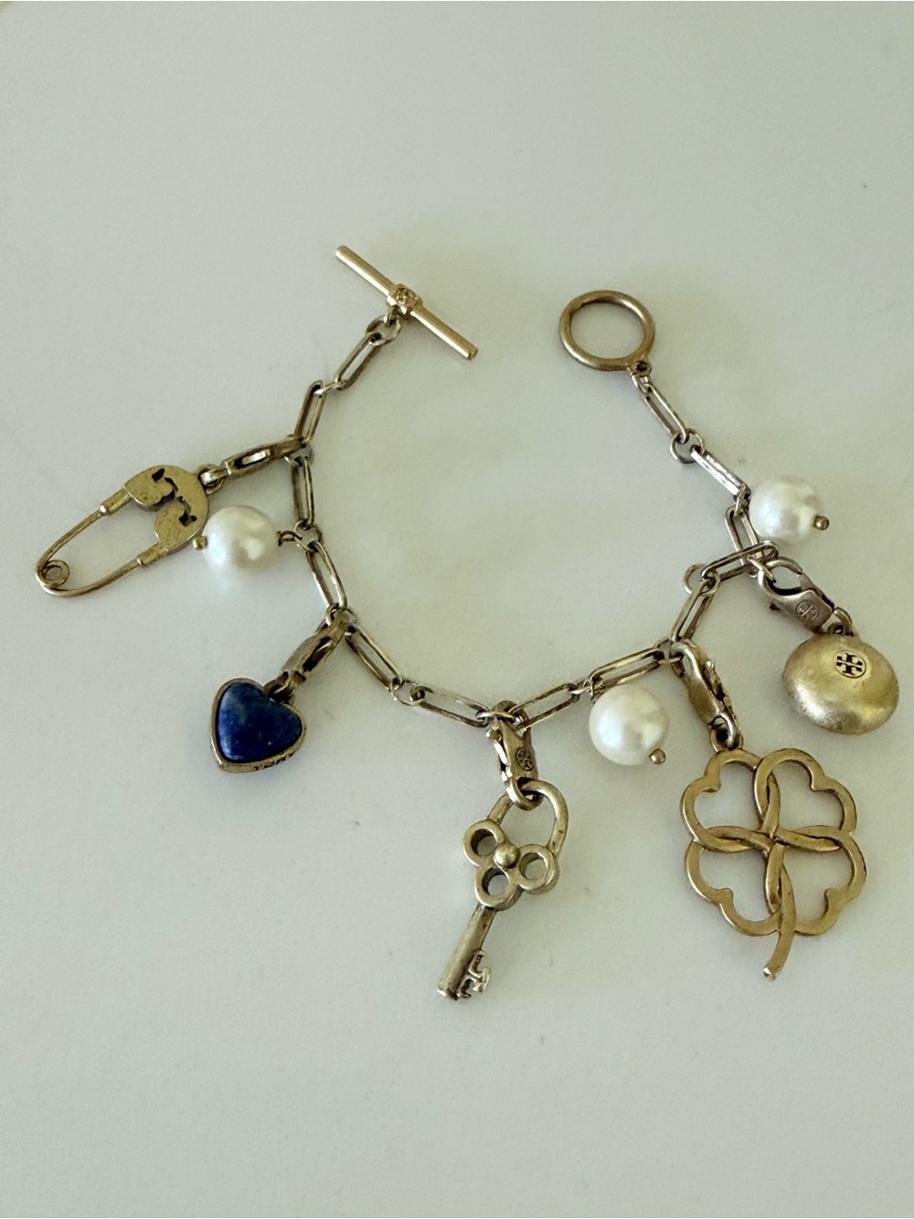 Gold tone Tory Burch beautiful bracelet with charms.